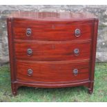 A bow front chest, of three long drawers flanked by reeded columns, width 37ins x depth 22ins x