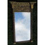 A gilt framed wall mirror, with ball and floral frieze, twist columns either side of the mirror