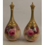 A pair of Royal Worcester covered vases, decorated with roses by Sedgley, shape number F103,