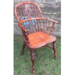 A 19th century yew wood Windsor chair, with Christmas tree pierced splat back, raised on turned legs