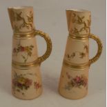 Two Royal Worcester blush ivory claret jugs, decorated with floral sprays, with gilt bands and