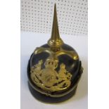 A Prussian pickelhaube style helmet, with pointed gilt spike and ornate gilt crest to the front