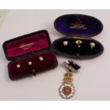A cased set of three dress studs, stamped '18ct', together with another similar cased set of three