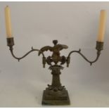 A 19th century gilt metal candelabrum, the column formed as an eagle on a perch with leaf moulded