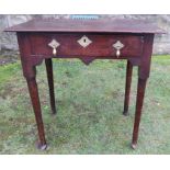 An 18th century oak side table, fitted with a drawer, raised on turned legs terminating in pad feet,