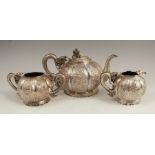 A late 19th century Chinese Export silver three piece tea set, comprising teapot, milk jug and sugar