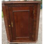 An 18th century oak corner cupboard, with inlaid paterea to the top, width 30ins