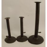 A pair of metal candlesticks, with slide ejectors, on circular bases, height 7.5ins, together with a