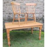A pine kitchen table, raised on turned legs, having an end drawer, 35ins x 60ins, height 29.5ins,