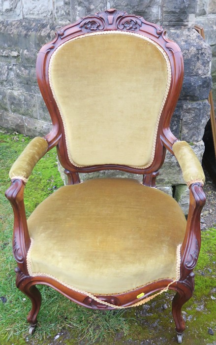 A Victorian show wood grandfather's chair, raised on short cabriole legs