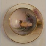 A Royal Worcester miniature tea cup and saucer, the interior of the cup and the saucer decorated