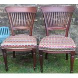 A pair of mahogany chairs, with tapestry seats, together with a pair of oak open arm dining chairs