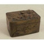 An Oriental metal pill box, embossed with figures and flowers, 1.75ins x 1.25ins, height 0.75ins,