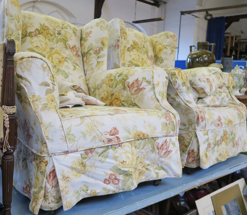 A pair of upholstered wing armchairs