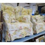 A pair of upholstered wing armchairs