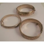 A silver hinged bangle, together with two others