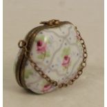 A 20th century Limoges porcelain pill box, formed as a handbag with gilt metal mounts and