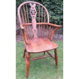 A yew wood wheel back Windsor armchair