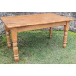 A pine kitchen table, on turned legs, 60ins x 34.5ins, height 31ins