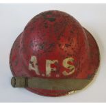 A WW2 metal helmet, painted red with the letters "A.F.S." in white to one end