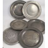 Five Antique pewter broad rim chargers, four with touch marks, diameter 17.5ins and down, together