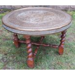 A brass topped circular occasional table, on a folding base, diameter 23ins