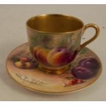 A Royal Worcester coffee cup and saucer, decorated with hand painted fruit by Ricketts, dated