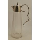 A silver plated and glass claret jug, the silver plated mount engraved with a date and initials,