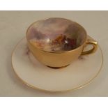 A Royal Worcester cabinet cup and saucer, the interior of the cup and the saucer decorated with