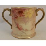 A Royal Worcester two handled loving cup, decorated with flowers to a blush ivory ground, height 5.