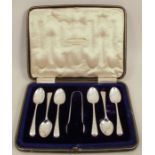 A cased set of six silver teaspoons together with matching sugar tongs, with engraved decoration and