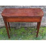 A Georgian mahogany fold over card table, with D shaped cross banded top and raised on four square