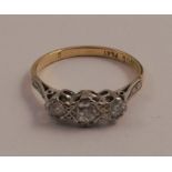 An 18 carat gold three stone illusion set diamond ring, the central old cut diamond approximately