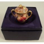 A Royal Worcester miniature sugar box and cover, decorated with fruit to a mossy background by