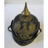 A Prussian pickelhaube style helmet, with pointed spike and ornate gilt eagle crest to the front,