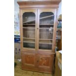 A pine glazed cabinet, with drawers below, width 42ins