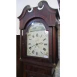 An Antique oak cased long case clock, with mahogany inlay, having a pained arched dial and