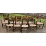 A set of 10 (8+2) North Country style wavy ladder back dining chairs, with rush seats and turned