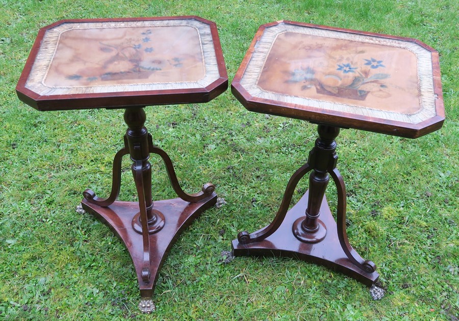 A pair of low rectangular tripod tables, decorated with an embroidered basket of fruit to the