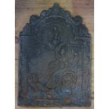 A cast iron fire back, decorated with a Classical figure in a chariot and birds, 25ins x 16ins