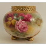 A Royal Worcester spherical shaped vase, decorated with roses by Harper, having a pierced neck and