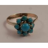 A 9 carat gold turquoise cluster ring, the nine stones cabochon cut, the central turquoise 5mm,