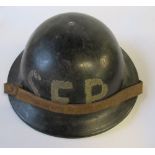 A black helmet, imprinted Plasfort to the rim, and the letters "SFP" to one end