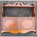 An Edwardian hanging wall shelf, fitted with two cupboard doors, width 22.5ins x depth 6.5ins x