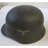 A WW2 German style helmet, with eagle carrying a swastika emblem to one side