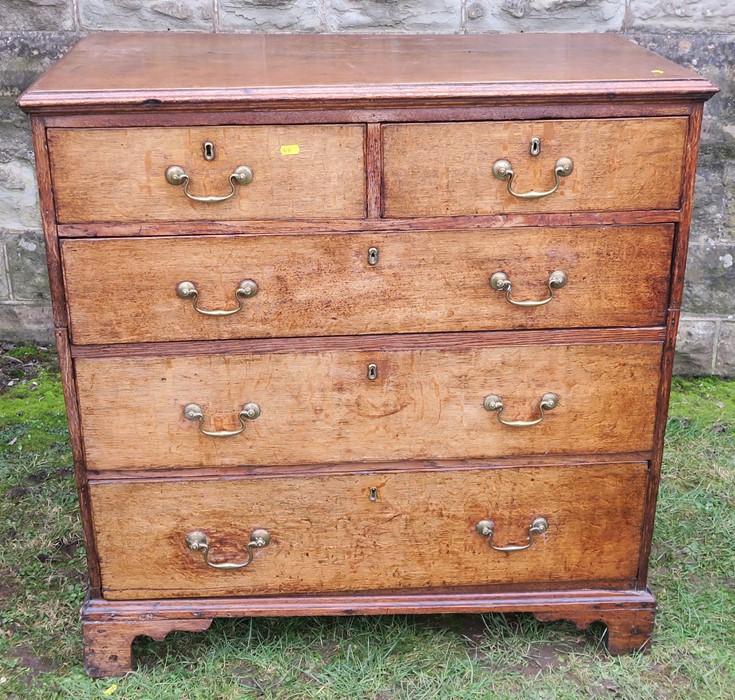 An 18th century oak chest, of two short drawers over three long drawers, raised on bracket feet, (