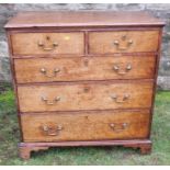 An 18th century oak chest, of two short drawers over three long drawers, raised on bracket feet, (