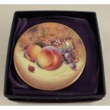 A Royal Worcester miniature side plate, decorated with fruit to a mossy background by Bowman, boxed,