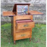 A 19th century mahogany dressing chest, the rising lid having drop flaps, and fitted with three