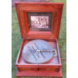 A Victorian walnut and inlaid table top polyphon, the lid inlaid with flowers and carved decoration,